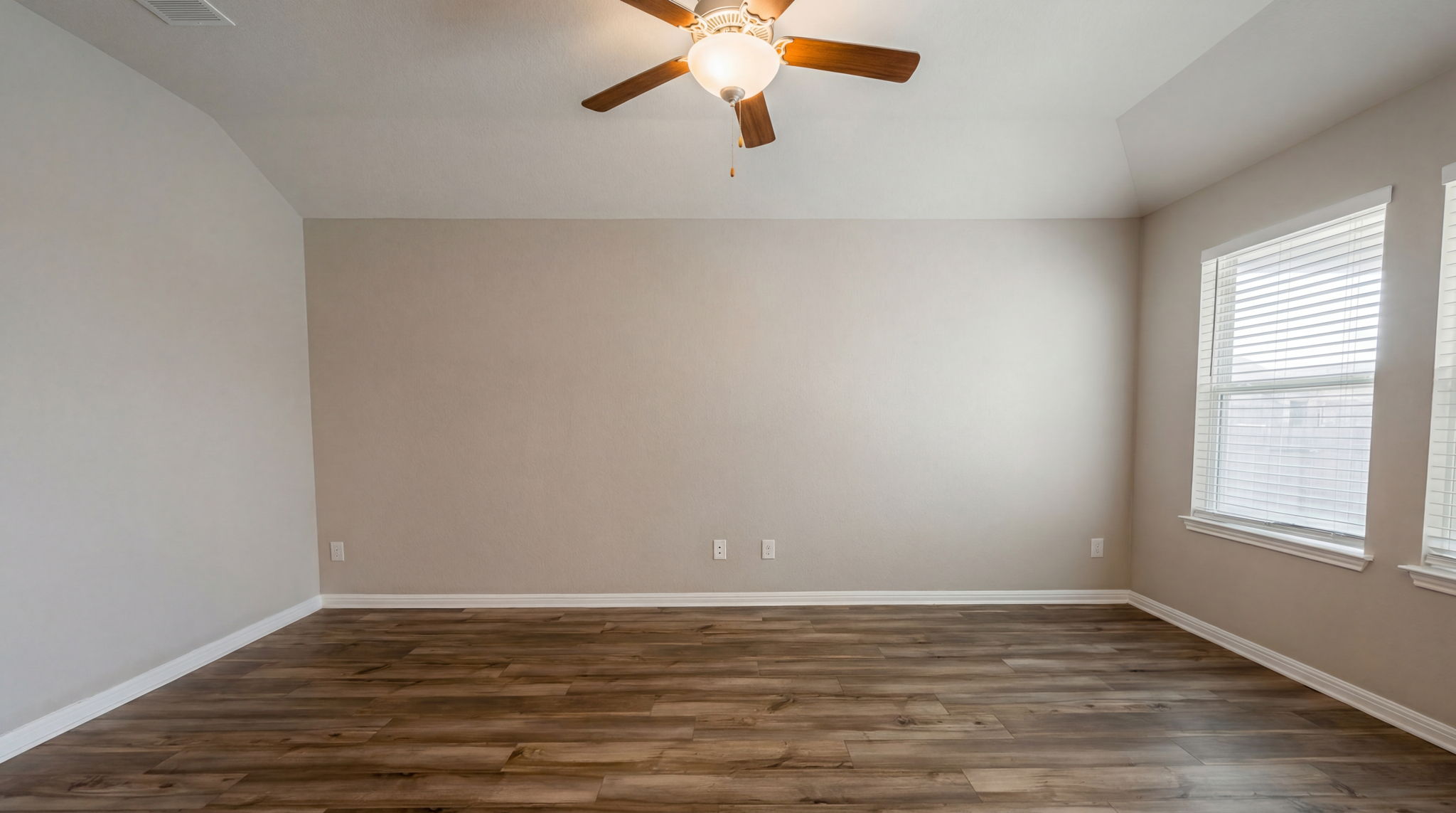 1003 Round Bale Road Hutto, TX 78634 - Photo 21 of 29 Empty room featuring dark wood-style flooring, a ceiling fan, and lofted ceiling
