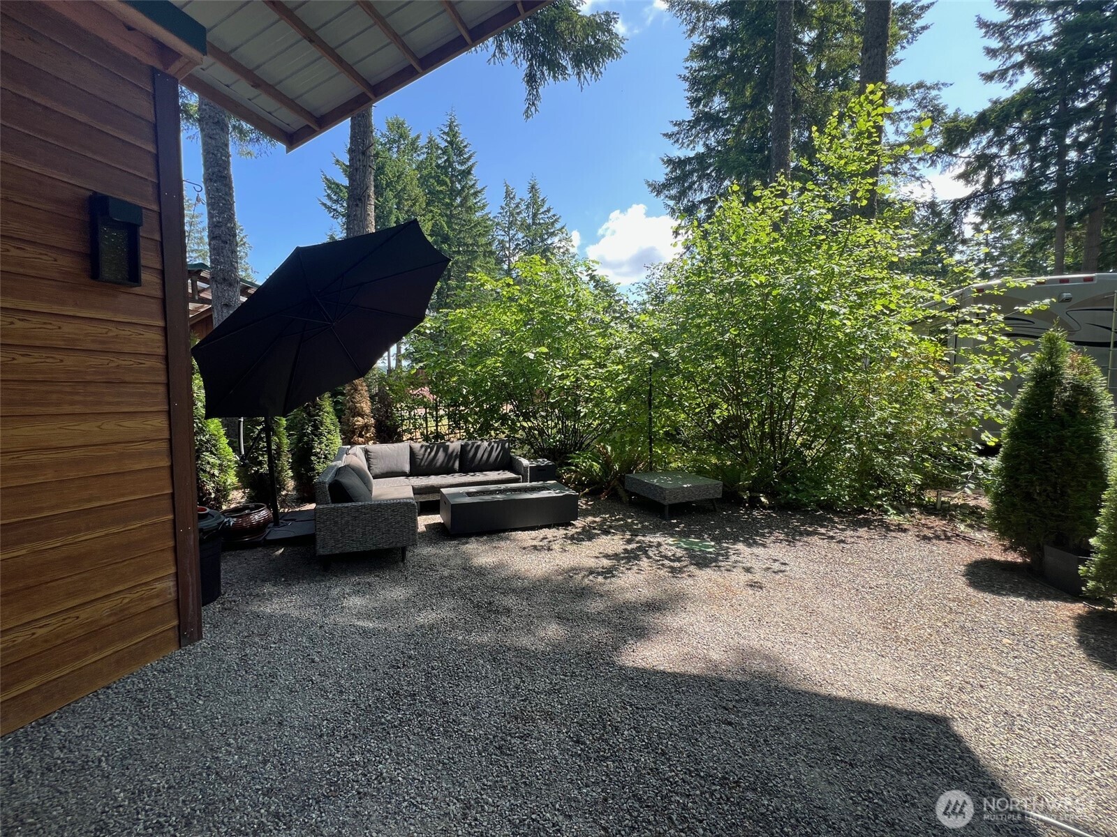 1546 Reservation Road Southeast, Unit 191 Olympia, WA 98513 - Photo 9 of 34 a view of a patio with table and chairs and potted plants