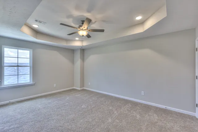 an empty room and chandelier fan