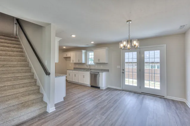a view of entryway with kitchen and wooden floor