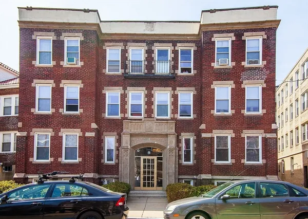 a front view of a brick building with many windows