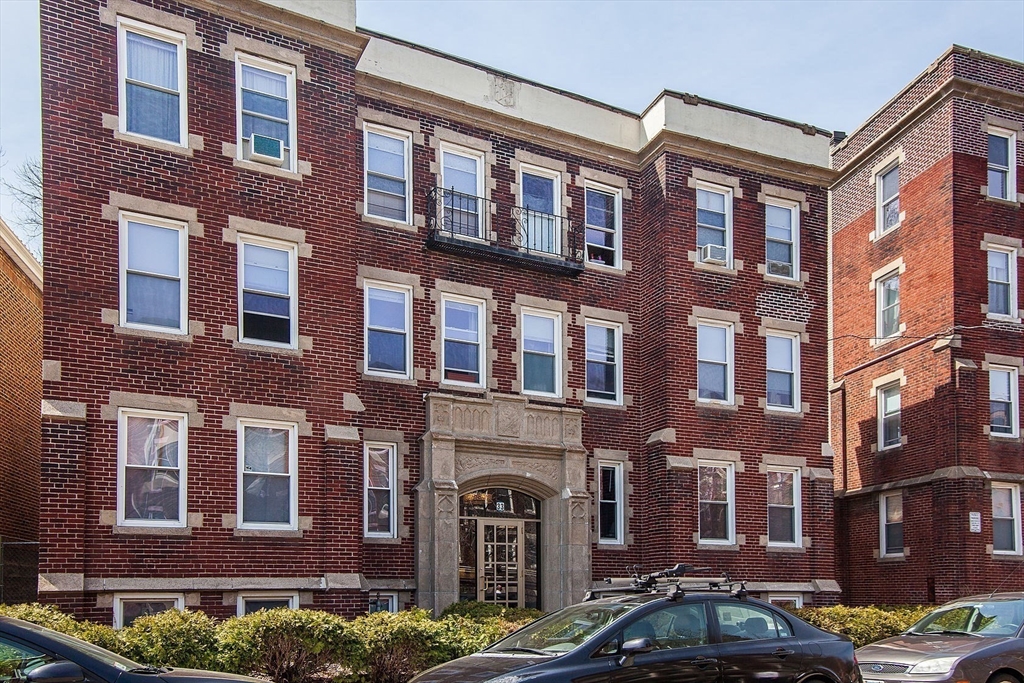 33 Walbridge Street, Unit 18 Boston, MA 02134 - Photo 12 of 13 a front view of a brick building with many windows