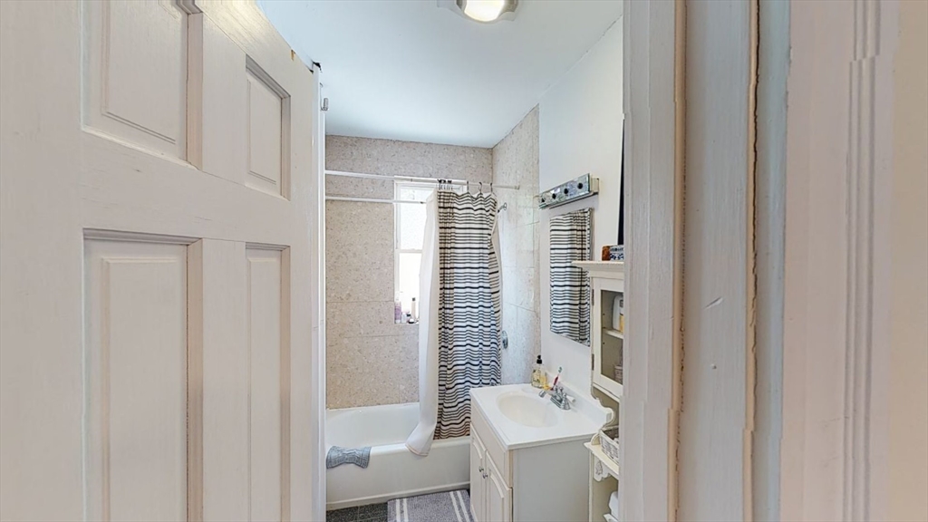 33 Walbridge Street, Unit 18 Boston, MA 02134 - Photo 5 of 13 a bathroom with a bathtub and shower