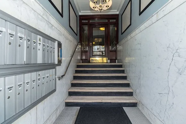 a front view of a building with car parked