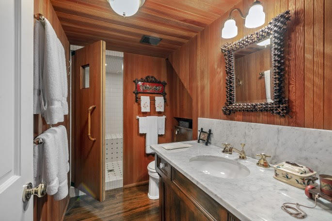 1555 East Valley Road Santa Barbara, CA 93108 - Photo 17 of 18 a bathroom with a granite countertop sink and a mirror