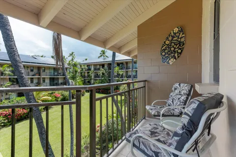 a view of a patio with table and chairs under an umbrella