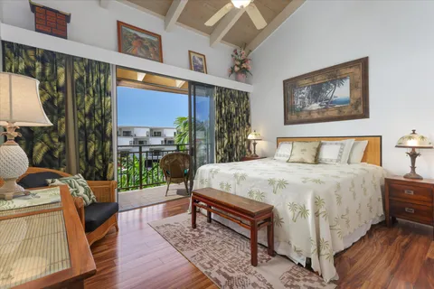 a bedroom with a bed and a dresser next to a window