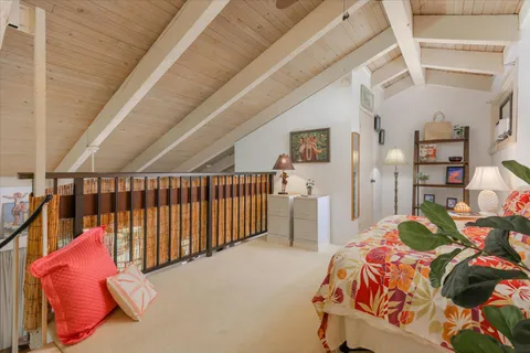 a bedroom with furniture and wooden floor