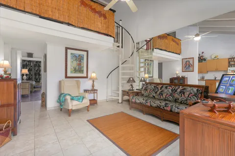 a living room with furniture a rug and white walls