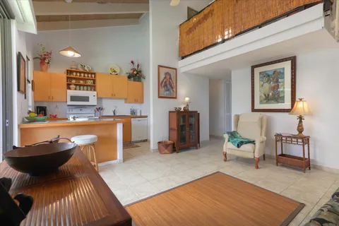 a living room with stainless steel appliances kitchen island granite countertop furniture and a kitchen view