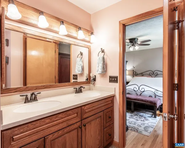 a en suite bathroom with a double vanity sink and a mirror