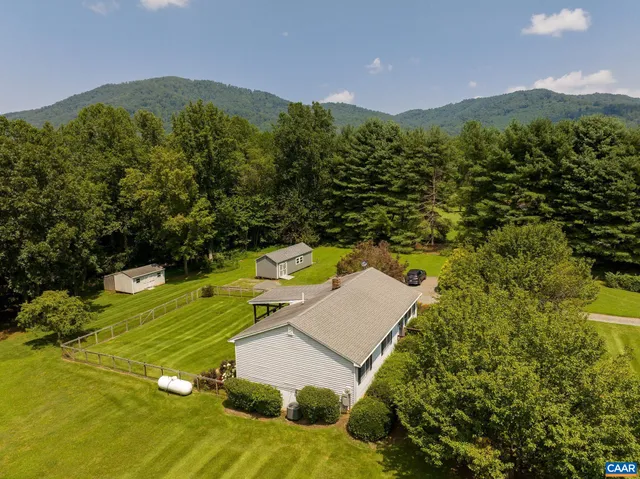 a view of a house with a yard and pool