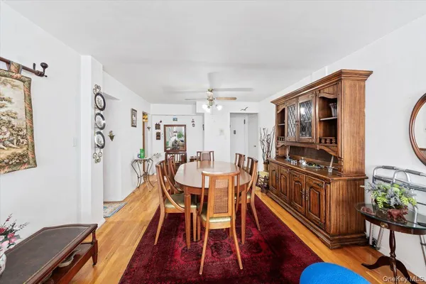 a dining room with furniture and wooden floor