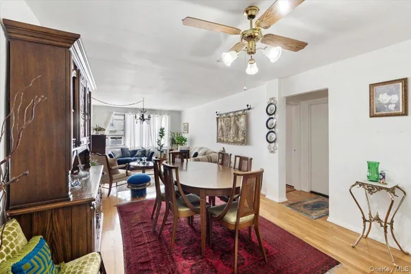 a view of a a dining room with furniture window and wooden floor