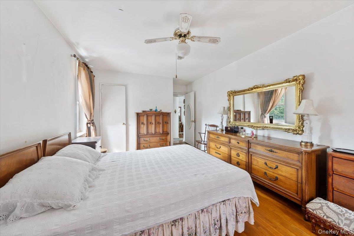 4265 Webster Avenue, Unit 7C Bronx, NY 10470 - Photo 18 of 22 a bedroom with a large bed and a chandelier
