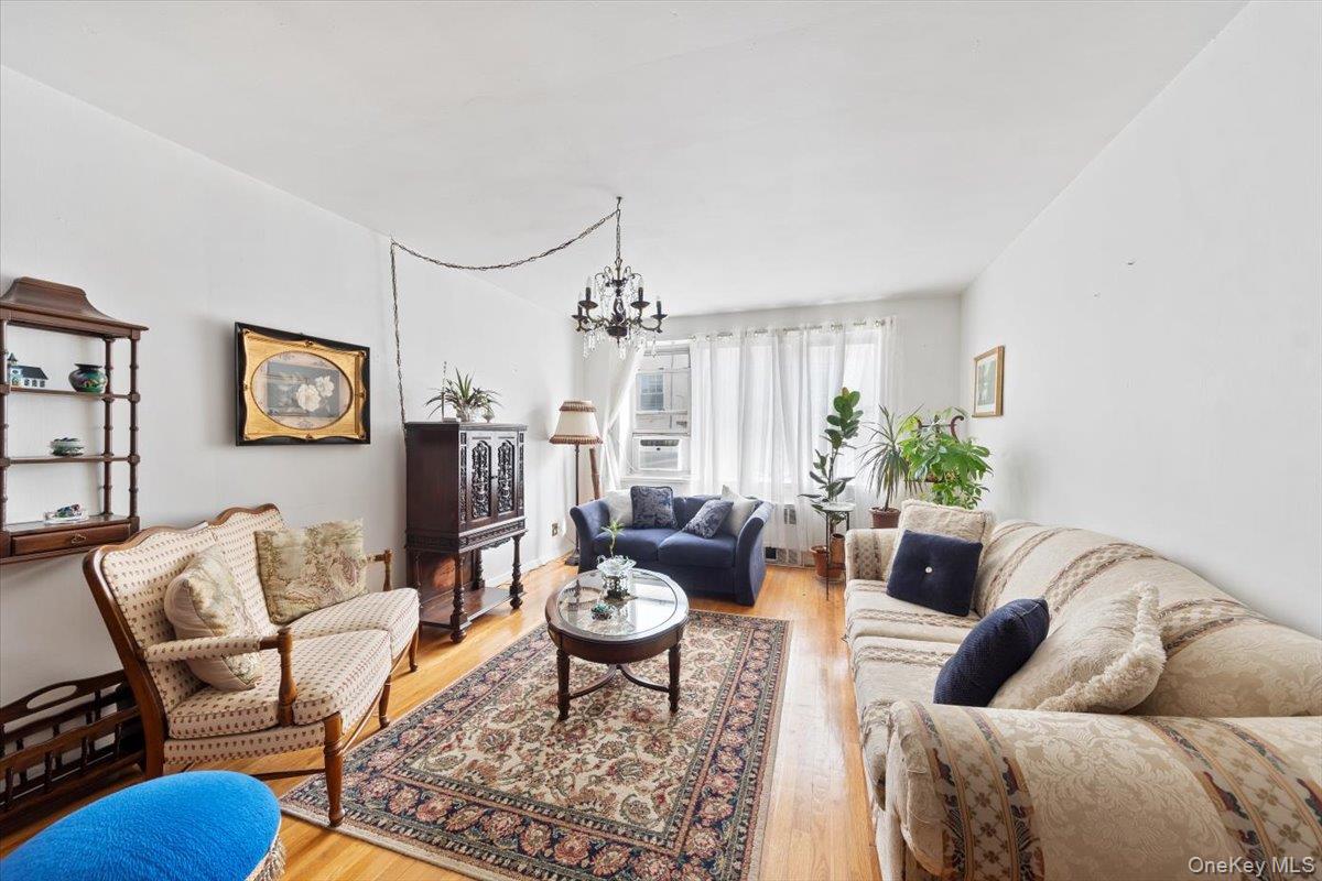 4265 Webster Avenue, Unit 7C Bronx, NY 10470 - Photo 7 of 22 a living room with furniture potted plant and a window