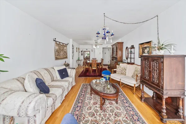 a living room with furniture and a chandelier