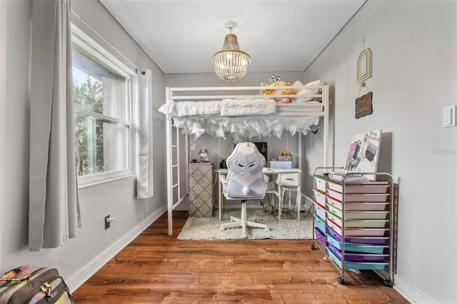 a bedroom with furniture and a flat screen tv
