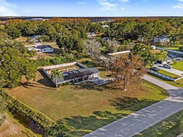 an aerial view of residential building with parking