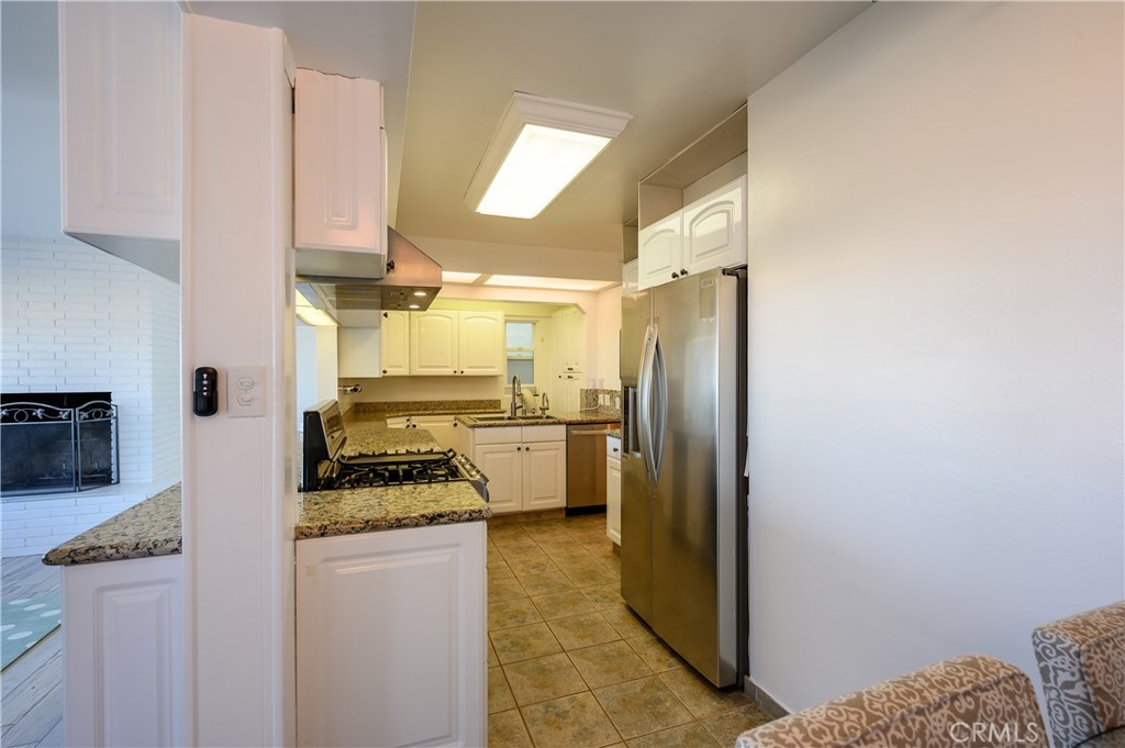 532 The Strand Hermosa Beach, CA 90254 - Photo 4 of 11 a kitchen with stainless steel appliances granite countertop a refrigerator and a stove
