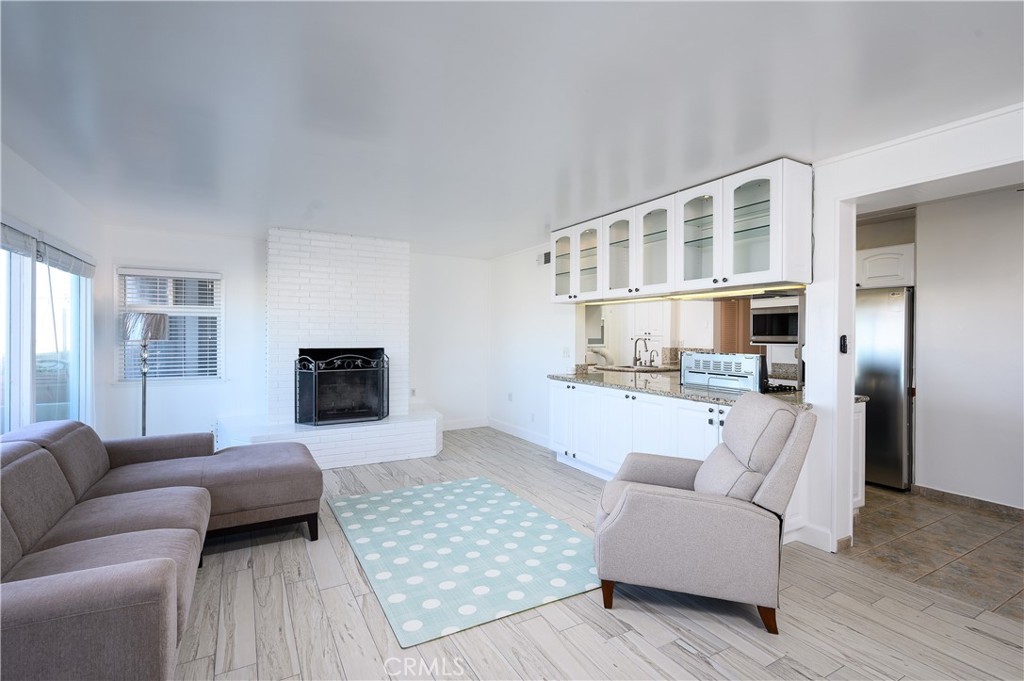532 The Strand Hermosa Beach, CA 90254 - Photo 5 of 11 a living room with furniture and a fireplace