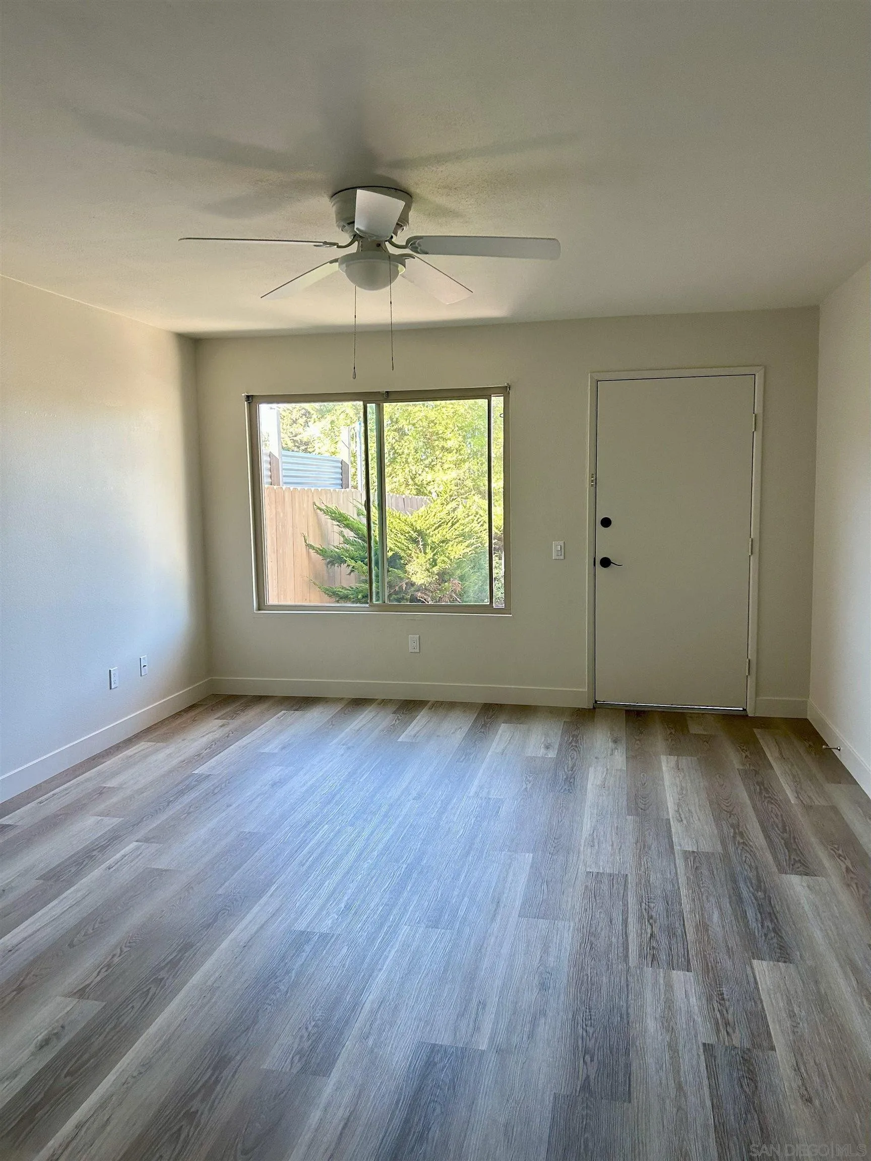 225 Melrose Avenue, Unit 1 Encinitas, CA 92024 - Photo 4 of 16 wooden floor in an empty room with a window