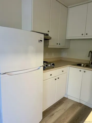 a kitchen with stainless steel appliances a cabinets and a stove top oven