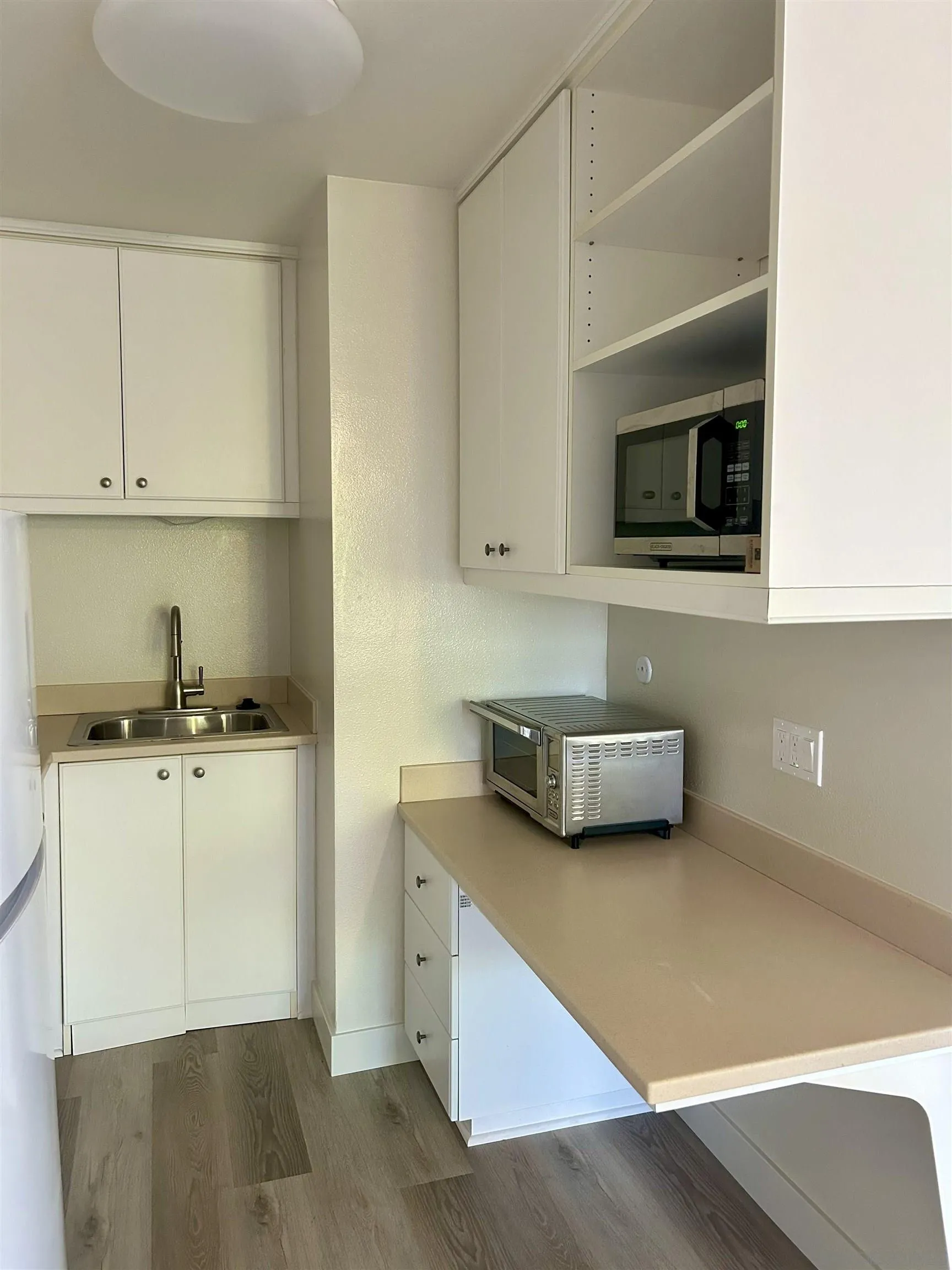 225 Melrose Avenue, Unit 1 Encinitas, CA 92024 - Photo 8 of 16 a kitchen with stainless steel appliances a cabinets and a stove top oven