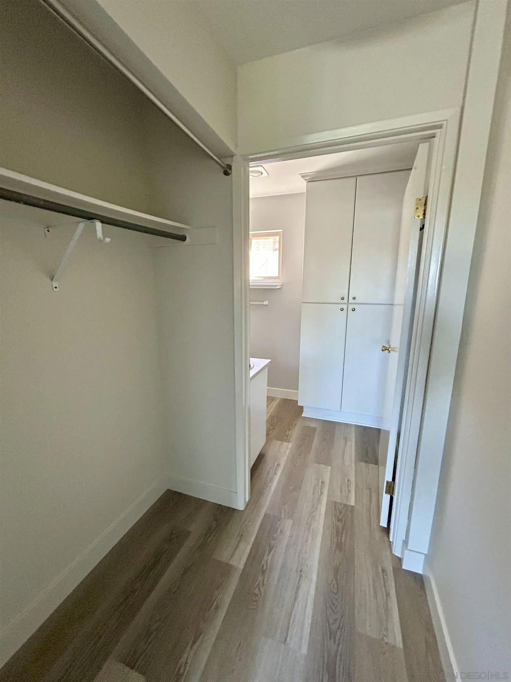 225 Melrose Avenue, Unit 1 Encinitas, CA 92024 - Photo 9 of 16 a view of a room with wooden floor and a bathroom
