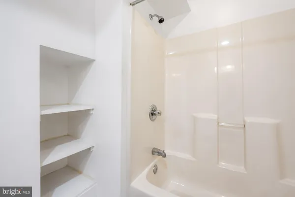 a bathroom with a bathtub and shower