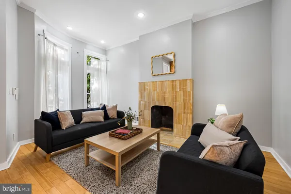 a living room with furniture and a fireplace