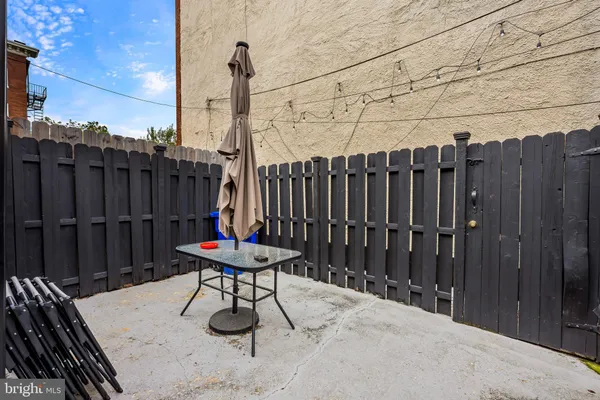 a backyard of a house with table and chairs