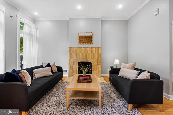 a living room with furniture and a fireplace