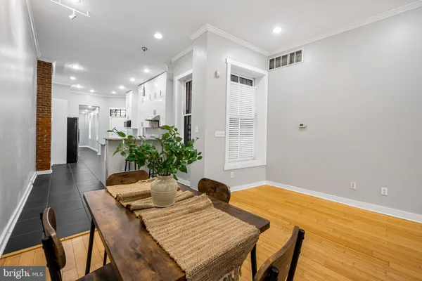 a view of a dining room with furniture and a potted plant