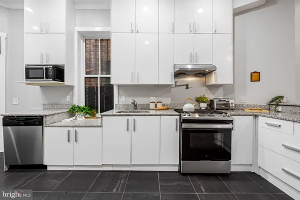 a kitchen with cabinets and white appliances