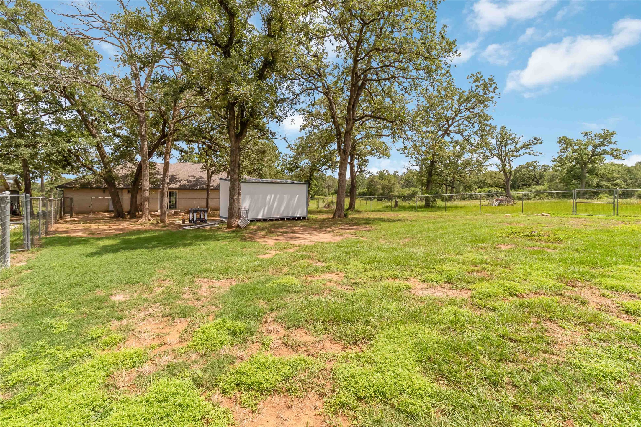1208 Jeddo Road Rosanky, TX 78953 - Photo 31 of 40 Mature trees and ample green space define this generous, fenced yard, complete with a practical storage shed.