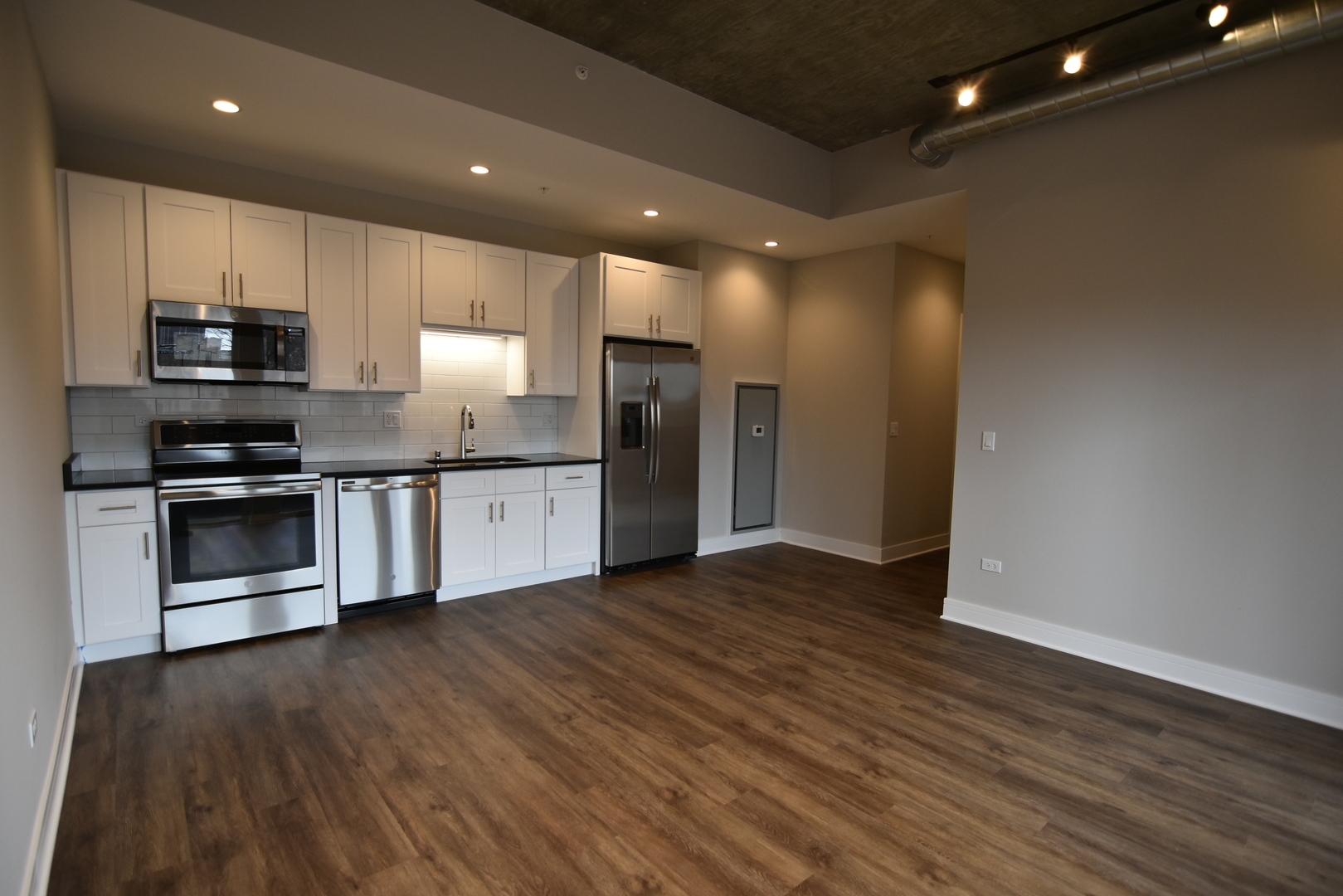 3833 North Broadway, Unit 313 Chicago, IL 60613 - Photo 2 of 8 a kitchen with stainless steel appliances granite countertop a stove a sink and a refrigerator