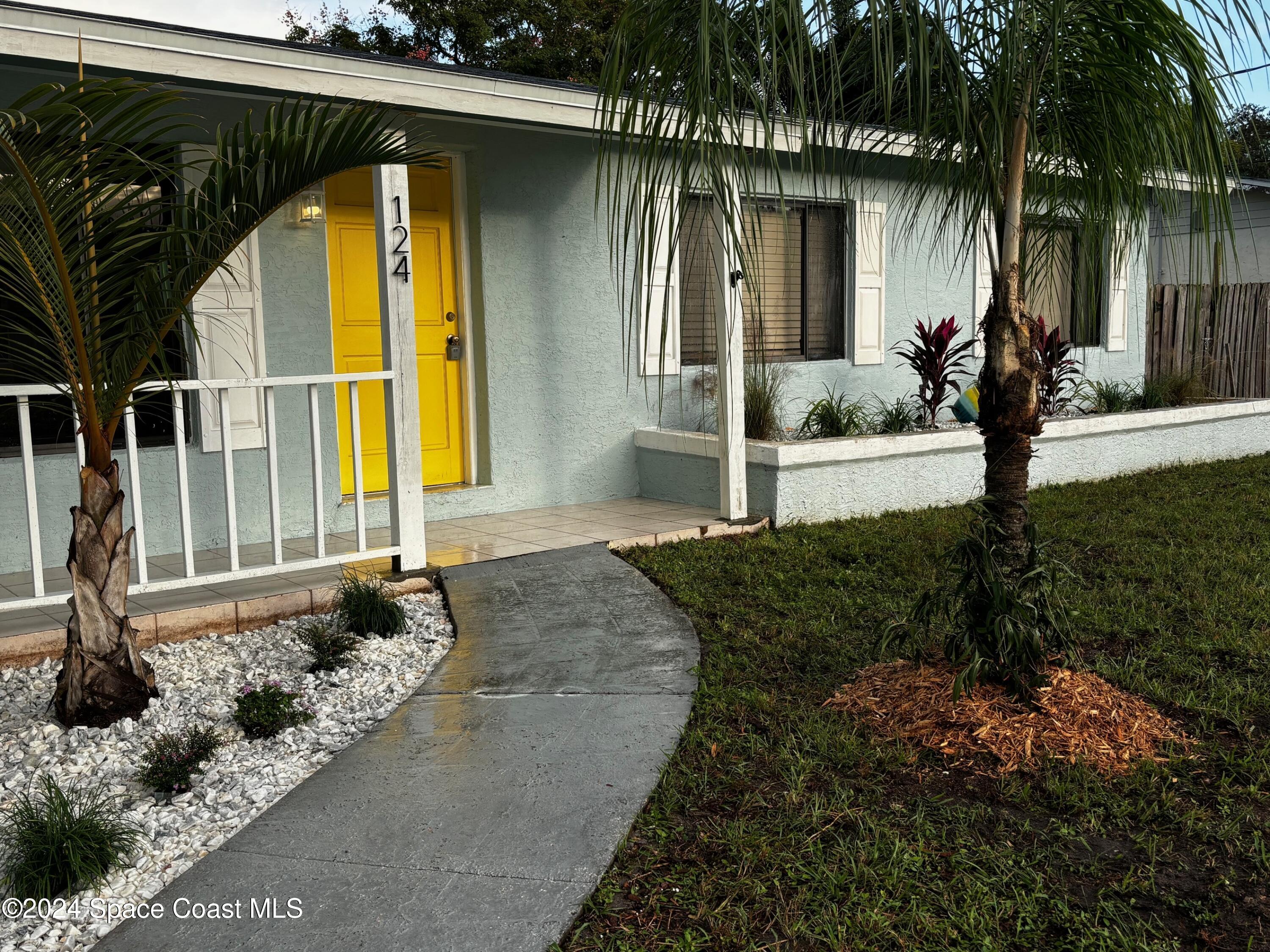 124 Monaco Road Melbourne, FL 32904 - Photo 4 of 24 a front view of a house with garden
