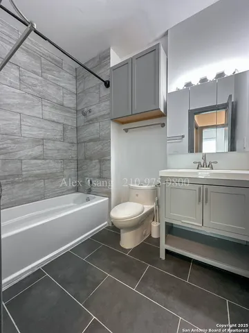 a bathroom with a sink a toilet and bathtub