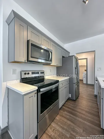 a kitchen with a stove microwave and sink