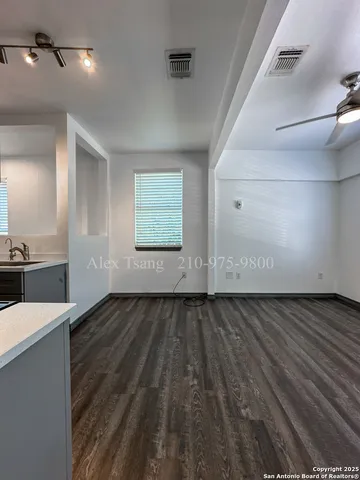 a view of a kitchen with kitchen island wooden floor and window