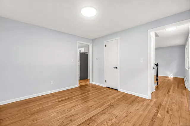 a view of hallway with wooden floor