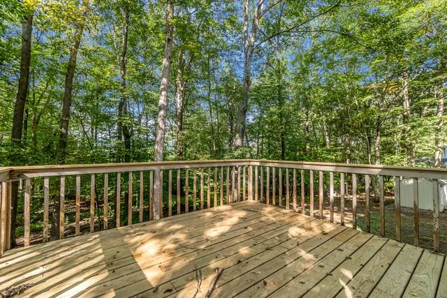 a balcony with wooden floor and fence