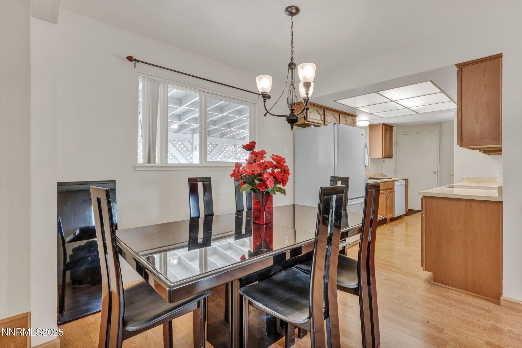 836 E Street Fernley, NV 89408 - Photo 11 of 53 a view of a dining room with furniture a chandelier and wooden floor