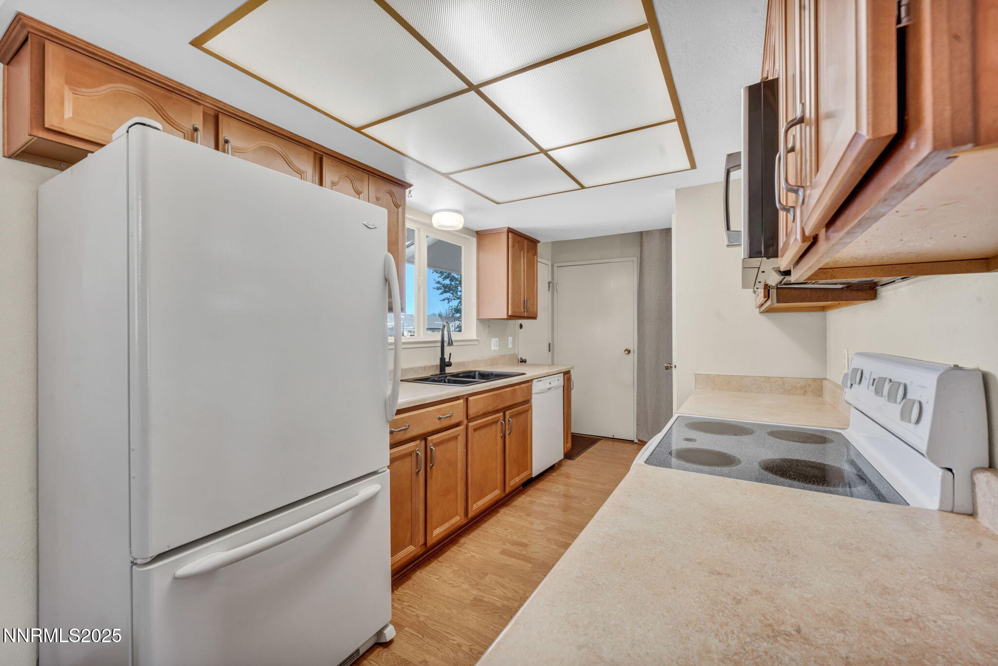 836 E Street Fernley, NV 89408 - Photo 12 of 53 a kitchen with granite countertop a refrigerator a sink and dishwasher