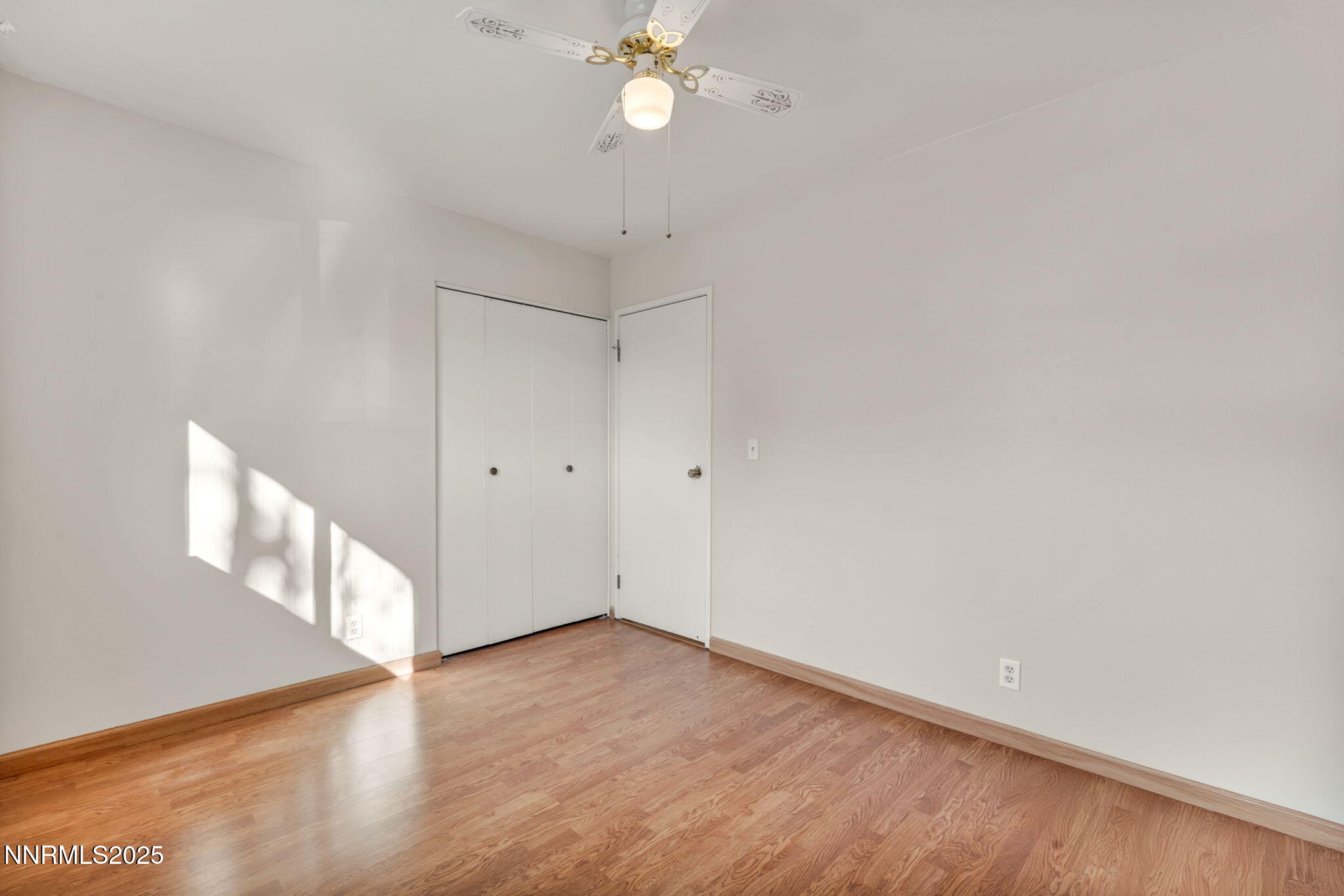 836 E Street Fernley, NV 89408 - Photo 33 of 53 a view of an empty room with wooden floor and a ceiling fan