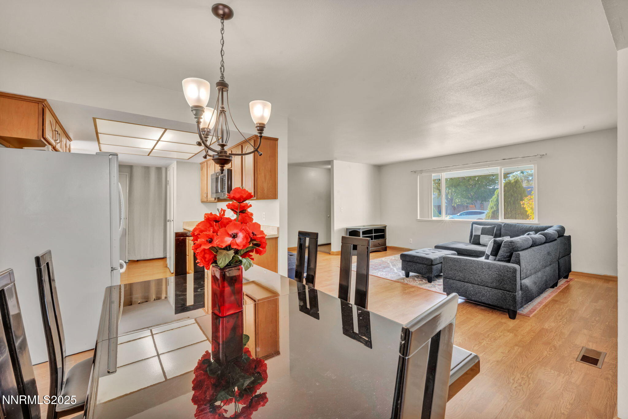 836 E Street Fernley, NV 89408 - Photo 9 of 53 a living room with furniture a chandelier and a flat screen tv