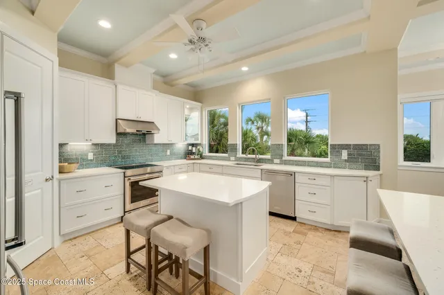 a large white kitchen with a large window