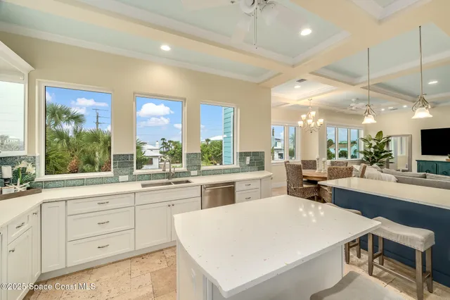 a dining room with a table chairs and a kitchen view