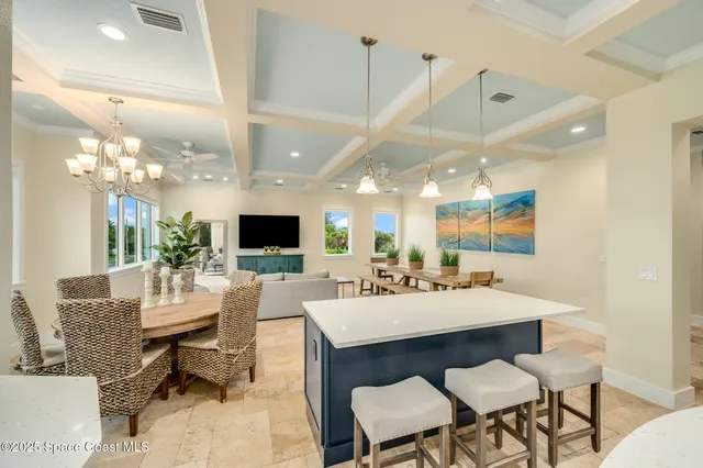 a living room with furniture a flat screen tv and a large window